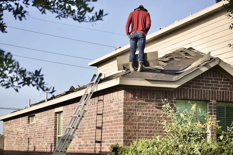 Professional roofer working on a residential roof in Olympic West